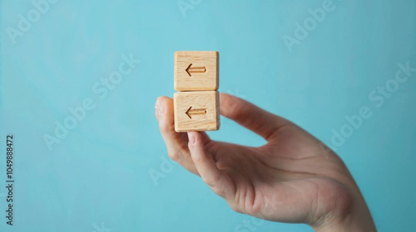 Fototapeta hand and a box with an arrow on the blue wall