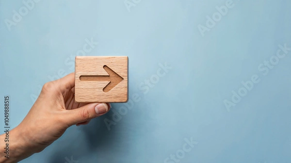 Fototapeta hand and a box with an arrow on the blue wall