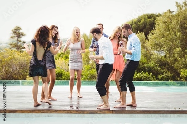 Fototapeta Happy young friends having drinks
