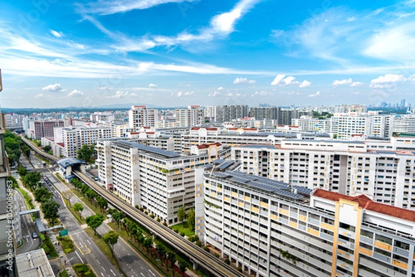 Fototapeta A landscape view of singapore HDB housing with bright sky and clouds