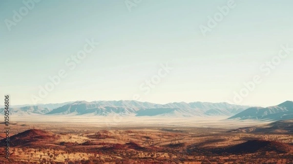 Fototapeta A serene view of the Australian Outback with vast red deserts and distant mountain ranges under a bright, clear sky, desert setting with expansive beauty