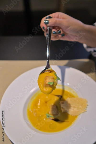 Obraz Rich Pumpkin Soup Spoonful with Crouton Garnish