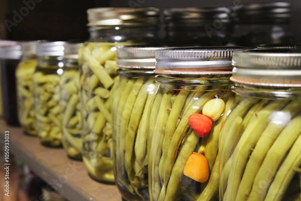 Fototapeta Pantry shelf of homemade canned beans; colorful display of old-fashioned food preserves