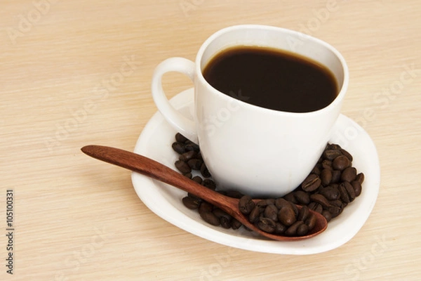 Fototapeta Cup of coffee on a table with a wooden spoon