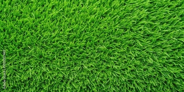 Fototapeta A close-up texture of lush, vibrant green artificial grass, showcasing the intricate details of the blades and the overall density of the surface.