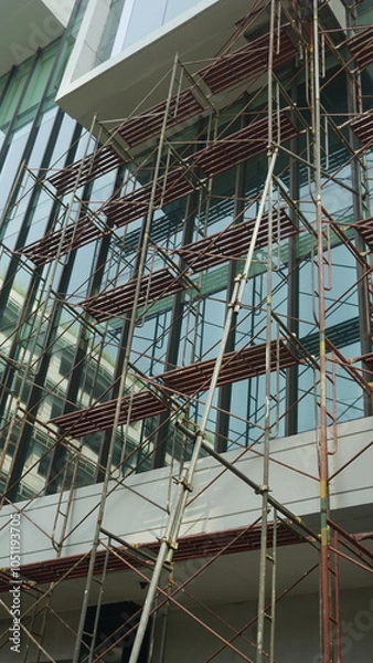 Fototapeta Scaffolding pole arrangement in a renovation project in an office building
