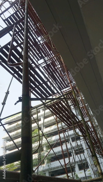 Fototapeta Scaffolding pole arrangement in a renovation project in an office building
