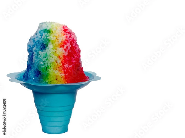 Fototapeta Hawaiian Rainbow Shaved ice, shave ice or a snow cone in a blue flower shaped cup against a white background.