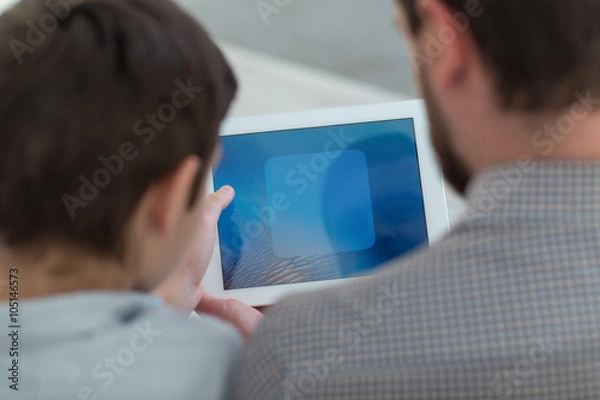 Obraz Cute friendly family is entertaining with modern technology