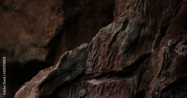Fototapeta Rugged Rock Surface with Red and Grey Layers