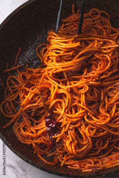 Fototapeta Spaghetti all'assassina is a typical Apulian recipe, Bari. Trendy first course, pasta cooked directly in a pan with tomato sauce, for a charred, crunchy and spicy flavor, close up, new Italian pasta