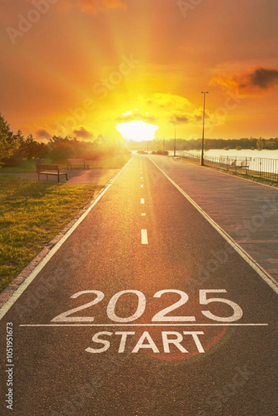Fototapeta Sunrise New Year 2025 start beginnings. Start to 2025 is written on empty asphalt path with bright golden sun rays on horizon. Positivity and success of the New year 2025. Motivational inscription