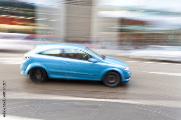 Fototapeta Car in motion blur, car driving fast in city