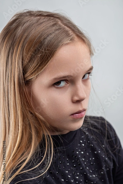 Fototapeta Portrait of a girl expressing negative emotions with intense gaz