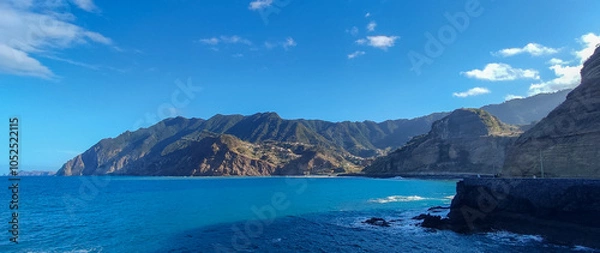 Fototapeta Coastal cliff scenery with turquoise ocean and dramatic cliffs in Madeira, Cais do Porto da Cruz
