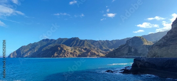 Fototapeta Breathtaking ocean view with towering cliffs and rugged coastline in Madeira, Cais do Porto da Cruz