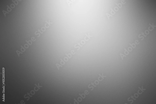 Fototapeta A grey background with a white light shining on it. Noisy backdrop with grain