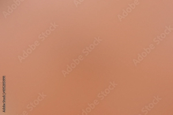 Fototapeta A tan background with a blurry image of a person. Noisy backdrop with grain