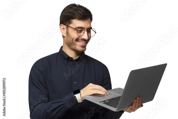 Obraz Portrait of young business man standing, holding laptop with happy smile