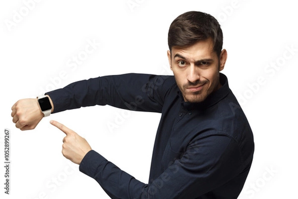 Fototapeta It's time to act! Young man pointing at watch with impatience as if asking to hurry up