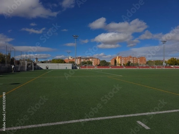 Obraz Empty Football Field Under a Clear Blue Sky