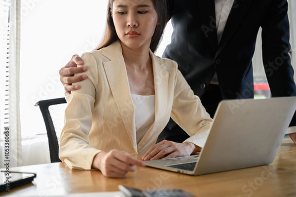 Fototapeta A male colleague or supervisor places a hand on the shoulder of an uncomfortable-looking female employee. Concept issues of sexual harassment, inappropriate behavior, and workplace dynamics.