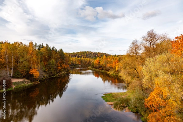 Fototapeta Autumn view of the river with colorful trees on the banks of the river