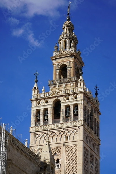 Fototapeta The Giralda Tower in Seville, Andalusia, Spain. It used to be the minaret of the Great Mosque, which was converted into the bell tower of the cathedral and declared a UNESCO World Heritage Site.