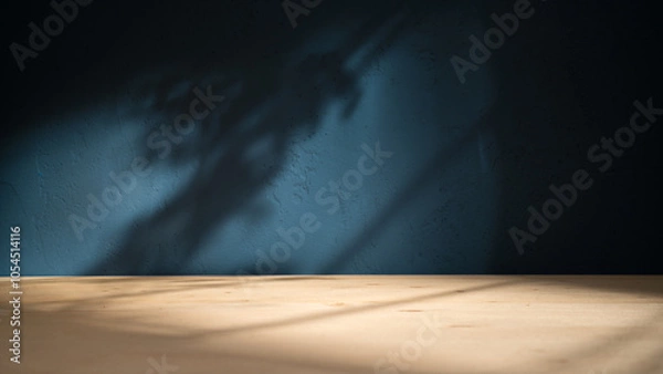 Fototapeta Table on blue texture wall background. Composition with leaves shadows on the wall and light reflections. Mock up for presentation, branding products, cosmetics food or jewelry.	
