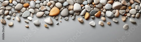 Fototapeta Many different colored rocks arranged on a gray surface