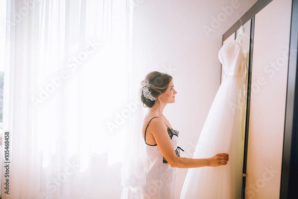 Obraz beautiful brunette stylish bride getting ready in the morning in the room