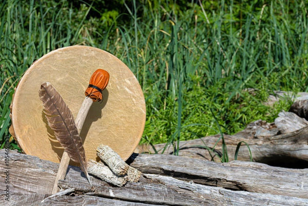 Fototapeta Handmade leather meditation drum with sacred feather and rattle. 