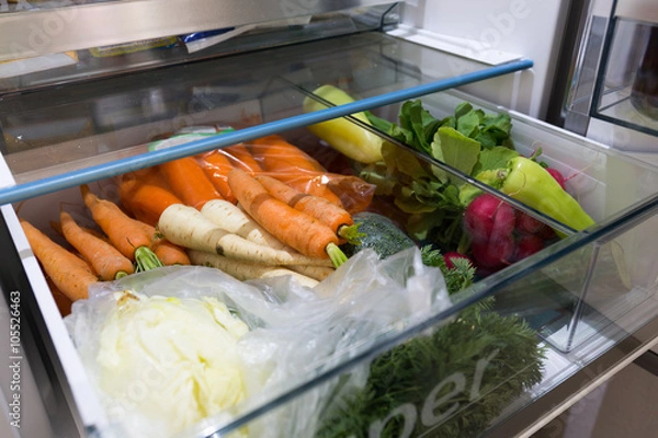 Fototapeta Open fridge filled with vegetables