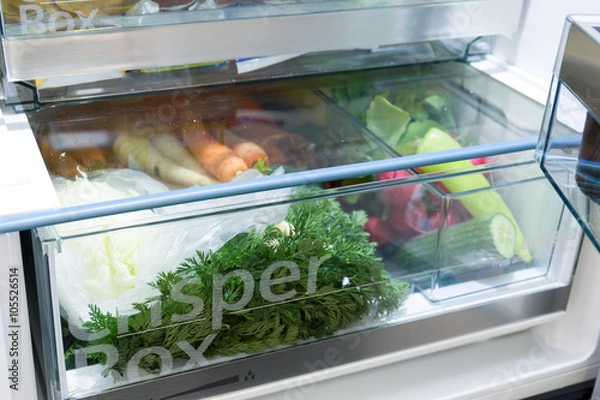 Fototapeta Open fridge filled with vegetables