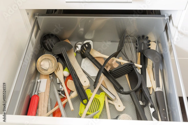 Fototapeta Opened drawer full of kitchenware