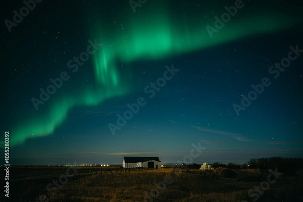 Obraz Dancing aurora borealis above Icelanding farm on the night sky