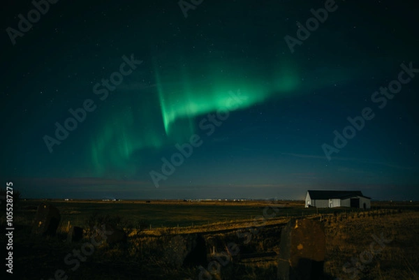 Obraz Dancing aurora borealis above Icelanding farm on the night sky