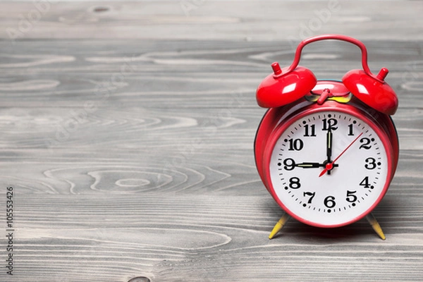 Fototapeta Red retro clock showing 09:00 am or pm