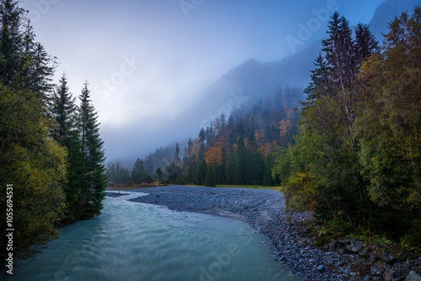 Fototapeta river in the karwendel mountains of austria in autumn at sunrise with fog 