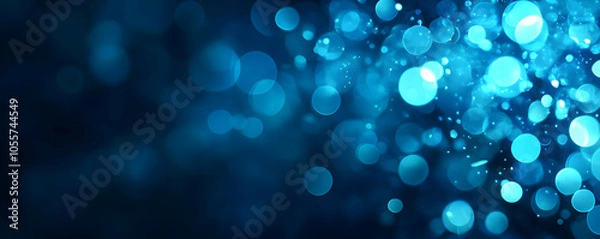Fototapeta A visually appealing abstract background featuring blue bokeh lights.