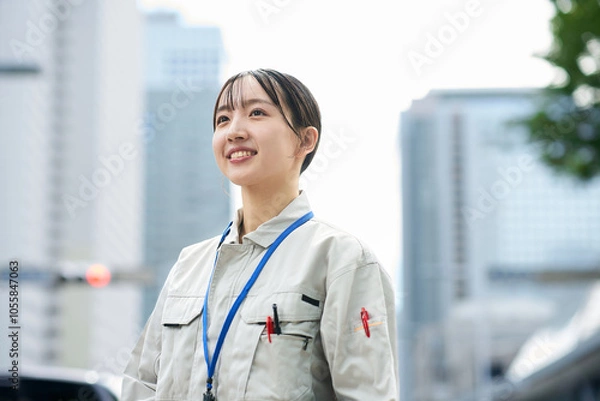 Fototapeta 作業服姿の若い女性