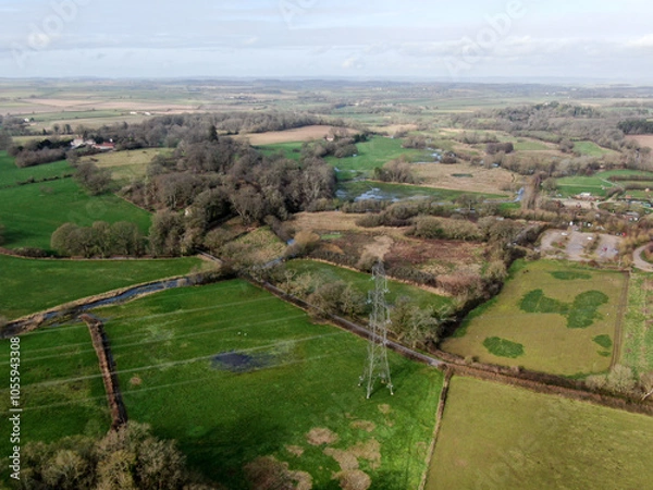 Obraz aerial view of an electricity pylon and line in open rural countryside in the UK