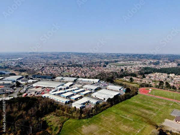 Obraz aerial view of mixed land use showing sports fields next to an industrial estate with residential housing in the background