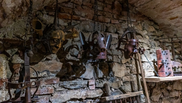 Obraz Scold's bridle hanging from a brick wall in an abandoned castle