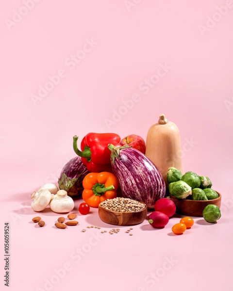 Fototapeta Vegan background with fresh seasonal autumn vegetables, vegan fall still life on pink