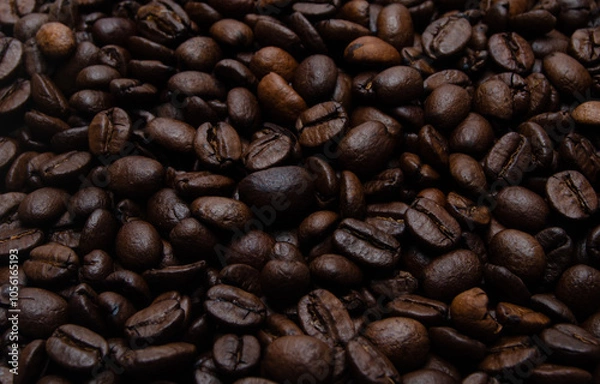 Obraz A pile of coffee beans. All stacked together, waiting to be ground into a delicious cup of coffee. A close-up shot of roasted coffee beans. Different types of delicious coffee beans.