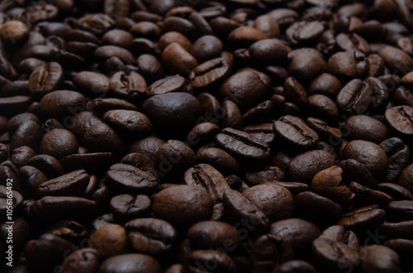 Obraz A pile of coffee beans. All stacked together, waiting to be ground into a delicious cup of coffee. A close-up shot of roasted coffee beans. Different types of delicious coffee beans.