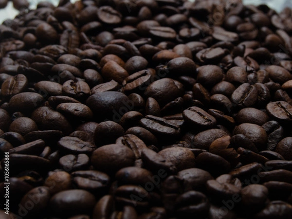 Obraz A pile of coffee beans. All stacked together, waiting to be ground into a delicious cup of coffee. A close-up shot of roasted coffee beans. Different types of delicious coffee beans.