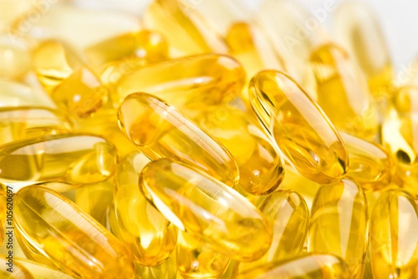 Obraz shiny yellow vitamin e fish oil capsule on white background