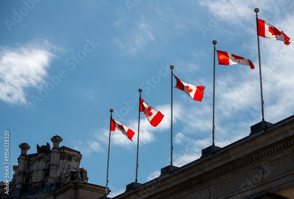 Fototapeta Canadian flags on the top of a building